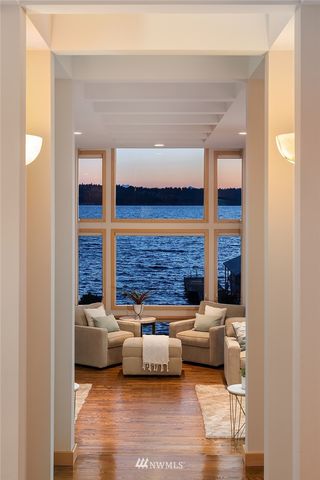 a living room with furniture and a floor to ceiling window