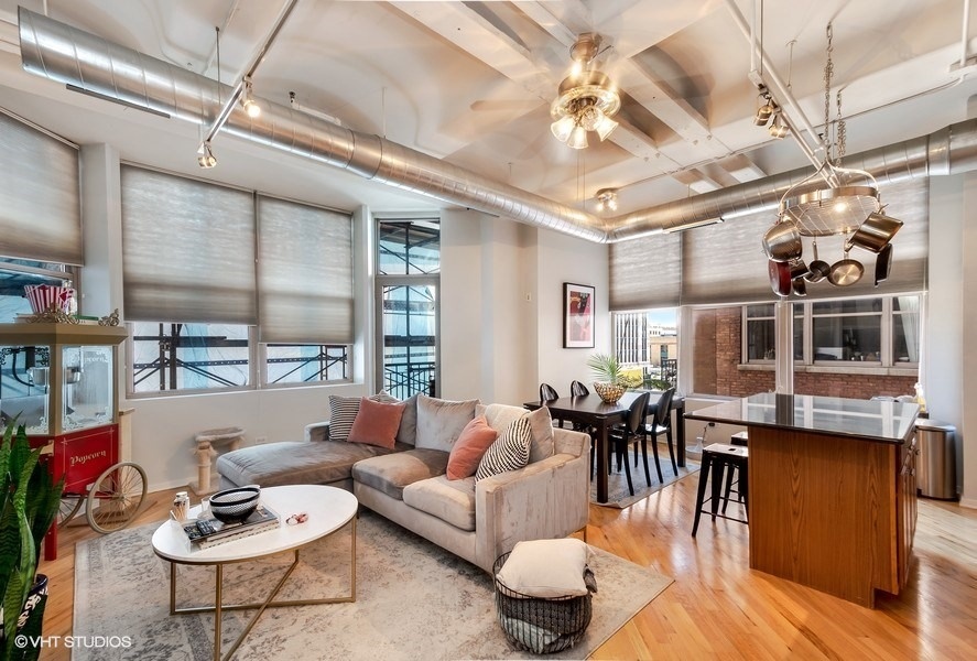 500 South Clinton Street, Unit 404 Chicago, IL 60607 - Photo 9 of 46 a living room with furniture and wooden floor