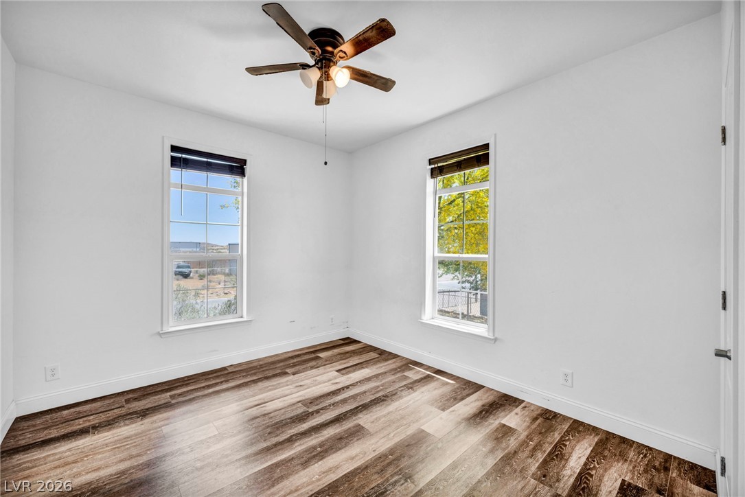 225 California Street Searchlight, NV 89046 - Photo 32 of 64 Hardwood floors and a ceiling fan create a comfortable atmosphere in this inviting space.