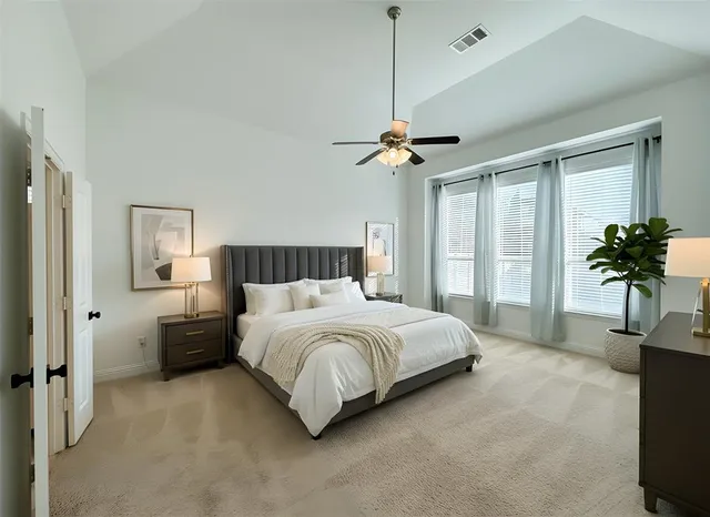 a bedroom with a bed chandelier and a window