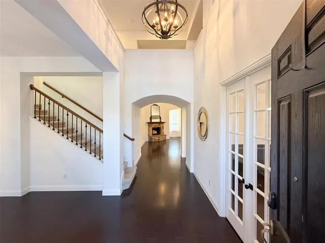 a view of staircase with lots of frames on wall and a window
