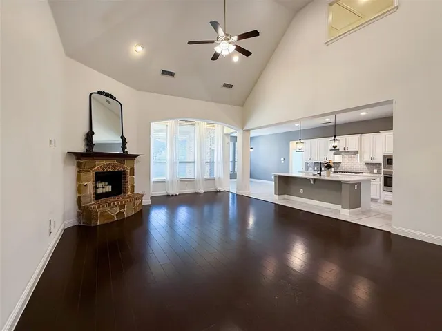 a view of a livingroom with fireplace wooden floor and a window