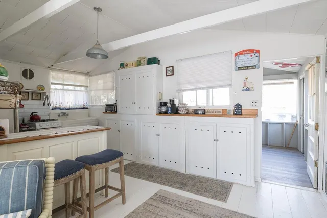 a kitchen with a sink a counter space appliances and cabinets