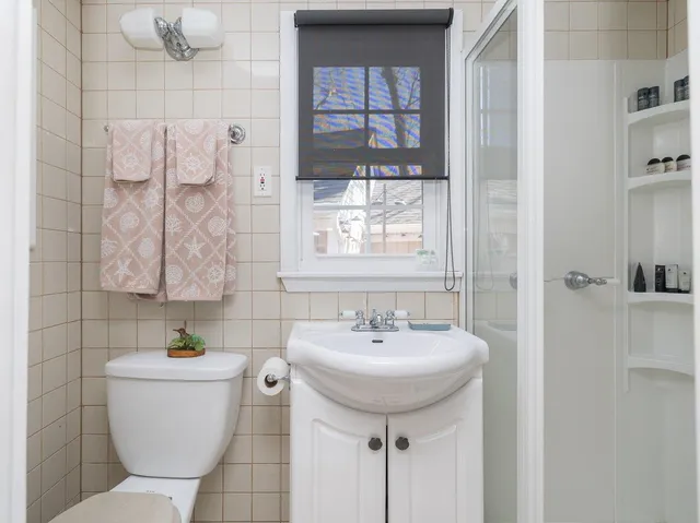 a bathroom with a sink toilet and shower