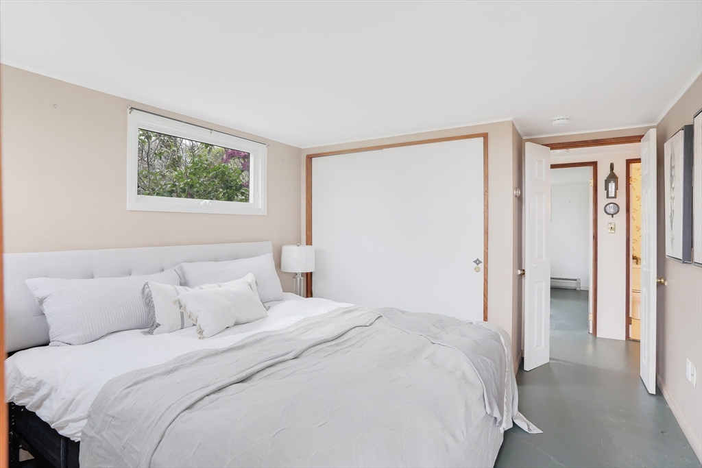 453 Lighthouse Road Aquinnah, MA 02535 - Photo 16 of 39 a bedroom with a bed and a painting on the wall