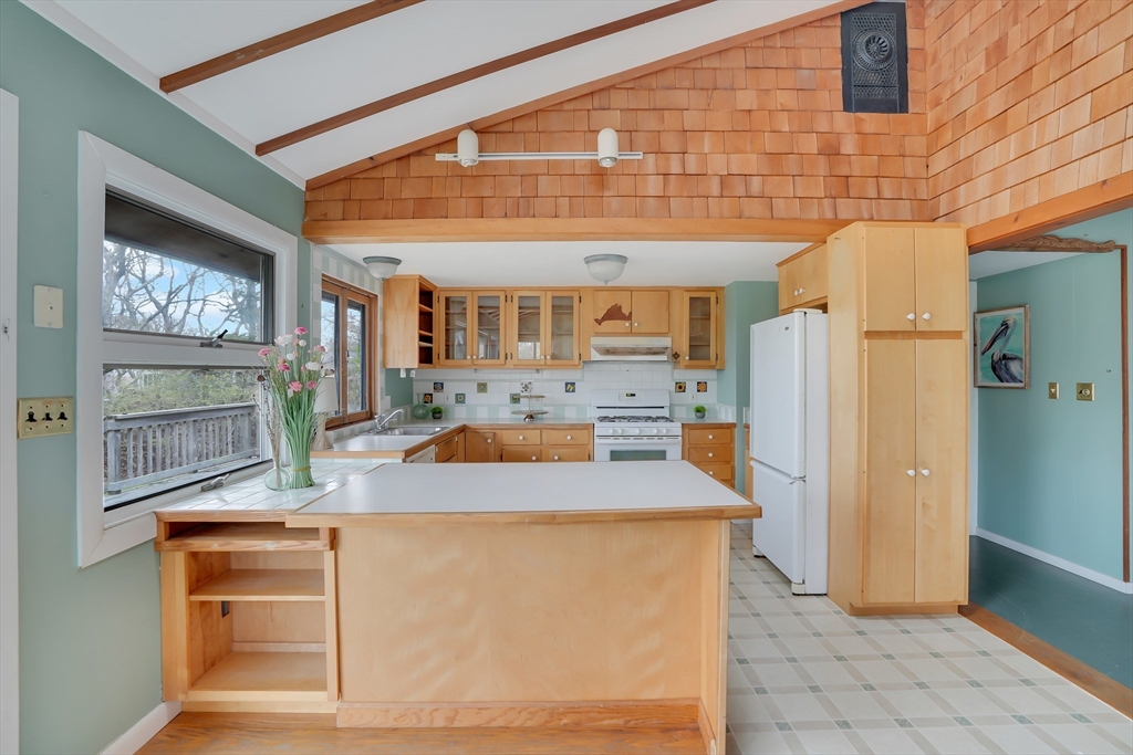453 Lighthouse Road Aquinnah, MA 02535 - Photo 6 of 39 a kitchen with granite countertop a refrigerator a stove and a sink