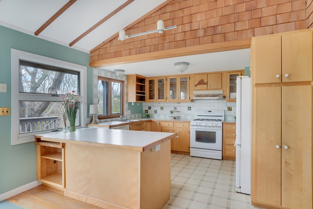 453 Lighthouse Road Aquinnah, MA 02535 - Photo 7 of 39 a large kitchen with stainless steel appliances granite countertop a sink and cabinets