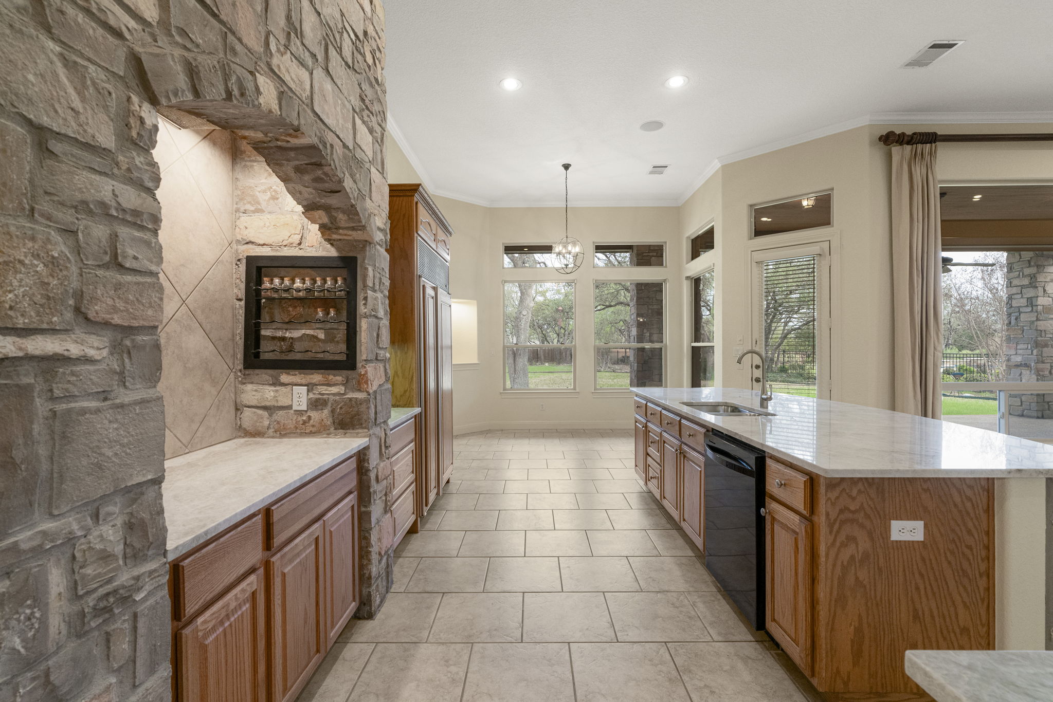 301 Goldridge Drive Georgetown, TX 78633 - Photo 11 of 40 *Photo taken prior to install* Enchanting stonework surrounds the built-in propane gas range.