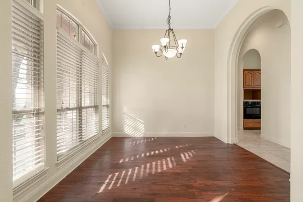 a view of a livingroom with wooden floor and windows