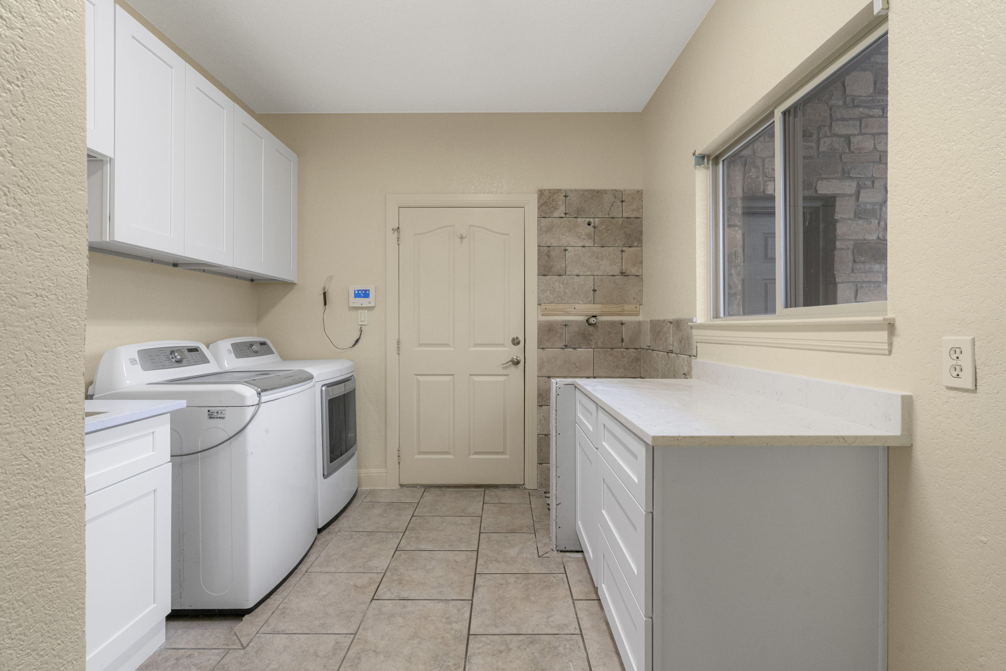 301 Goldridge Drive Georgetown, TX 78633 - Photo 29 of 40 The laundry room offers generous storage, a folding counter, a dog wash, and the W/D convey!