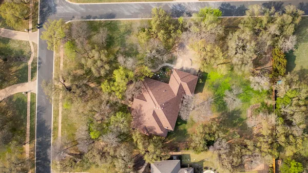 an aerial view of a house with a yard