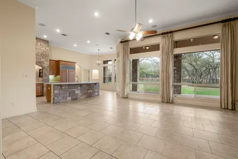 a view of a kitchen with a sink and a large window
