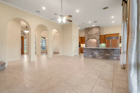 a view of a hallway with chandelier and fireplace