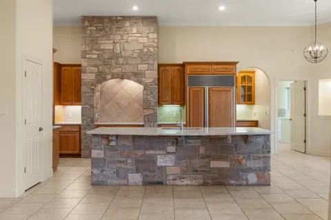 a bathroom with a granite countertop sink a mirror and shower