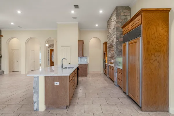 a kitchen with stainless steel appliances granite countertop a sink and a refrigerator