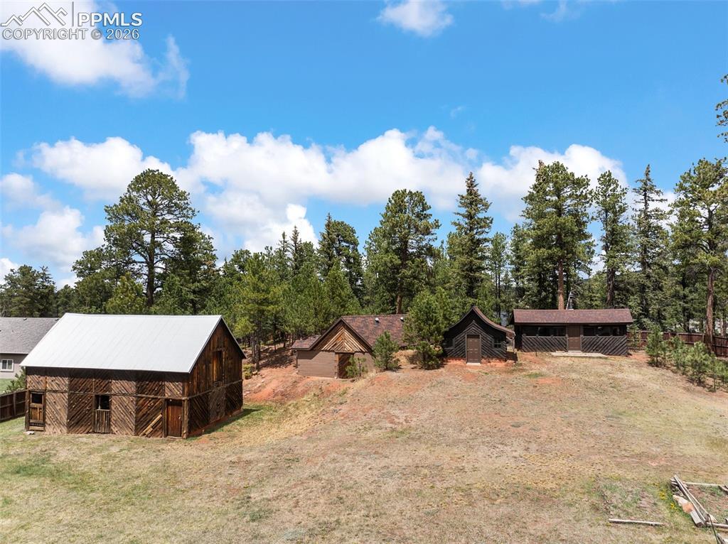 1100 Rampart Range Road Woodland Park, CO 80863 - Photo 34 of 50 The wooded property also includes the historic barn (built in 1886), ice house, and two cabins
