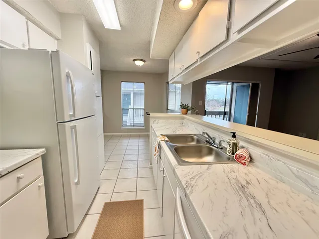 a view of washer and dryer with bathroom in the background