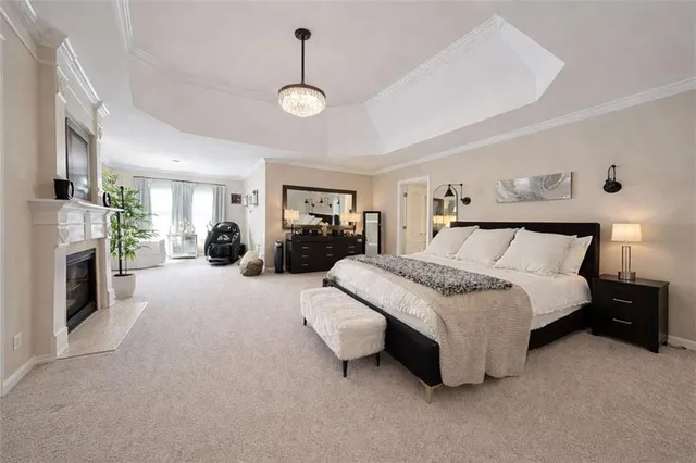 a spacious bedroom with a bed and fireplace