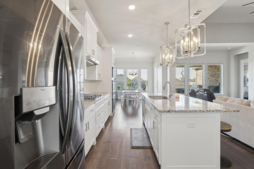 11375 Misty Ridge Drive Flower Mound, TX 76262 - Photo 36 of 36 a kitchen with kitchen island a sink appliances and cabinets