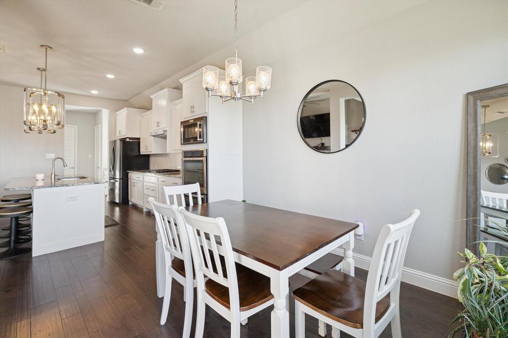 11375 Misty Ridge Drive Flower Mound, TX 76262 - Photo 11 of 36 a view of a dining room with furniture and chandelier