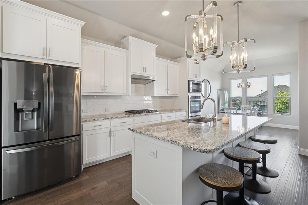 11375 Misty Ridge Drive Flower Mound, TX 76262 - Photo 13 of 39 a kitchen with stainless steel appliances granite countertop a sink refrigerator and cabinets