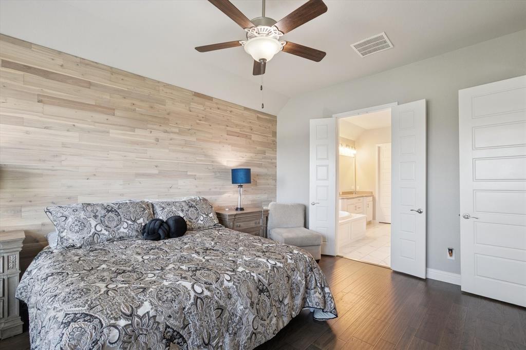 11375 Misty Ridge Drive Flower Mound, TX 76262 - Photo 15 of 36 a bedroom with a bed and a chandelier