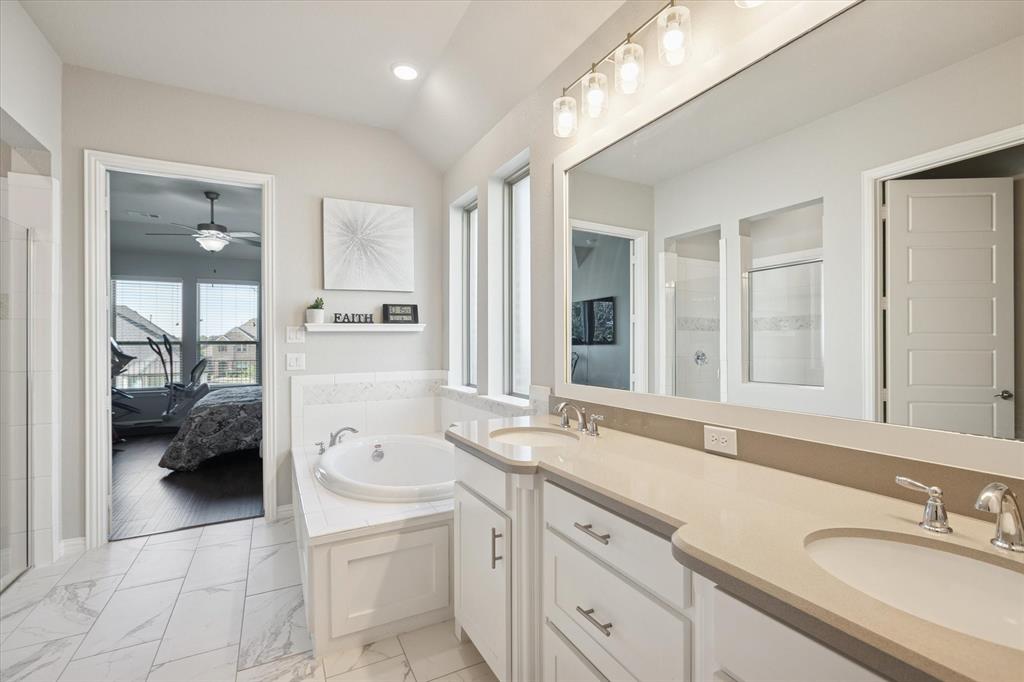 11375 Misty Ridge Drive Flower Mound, TX 76262 - Photo 18 of 36 a spacious en suite bathroom with a granite countertop double vanity sink a mirror and a shower