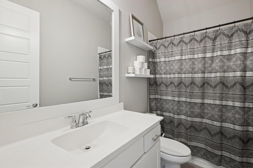 11375 Misty Ridge Drive Flower Mound, TX 76262 - Photo 23 of 36 a bathroom with a sink toilet and shower