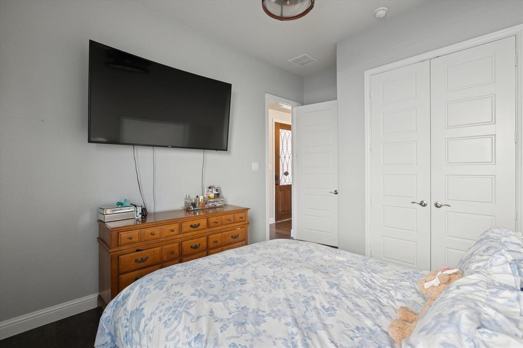 11375 Misty Ridge Drive Flower Mound, TX 76262 - Photo 28 of 36 a bedroom with a bed and a flat screen tv