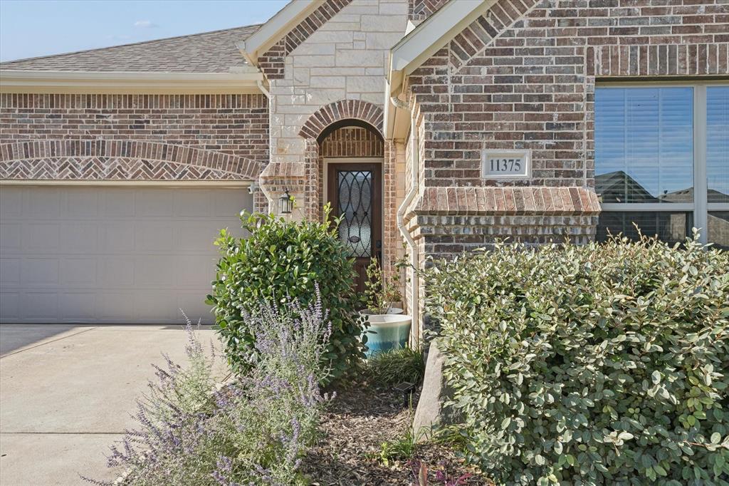 11375 Misty Ridge Drive Flower Mound, TX 76262 - Photo 4 of 39 a front view of a house with a garden