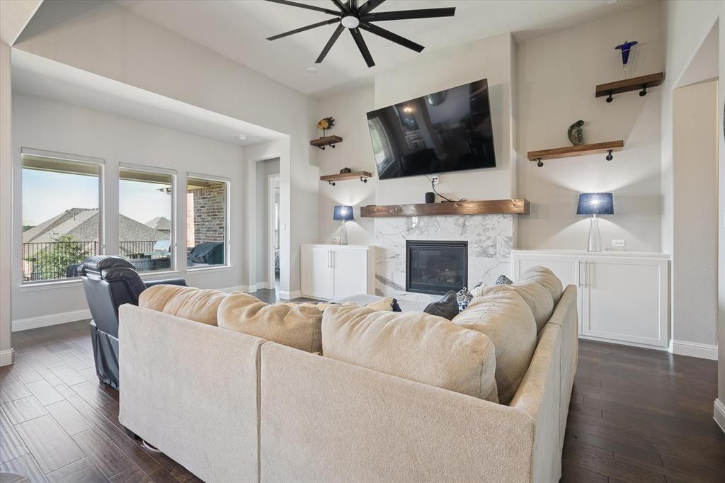 11375 Misty Ridge Drive Flower Mound, TX 76262 - Photo 7 of 39 a living room with fireplace furniture and a flat screen tv
