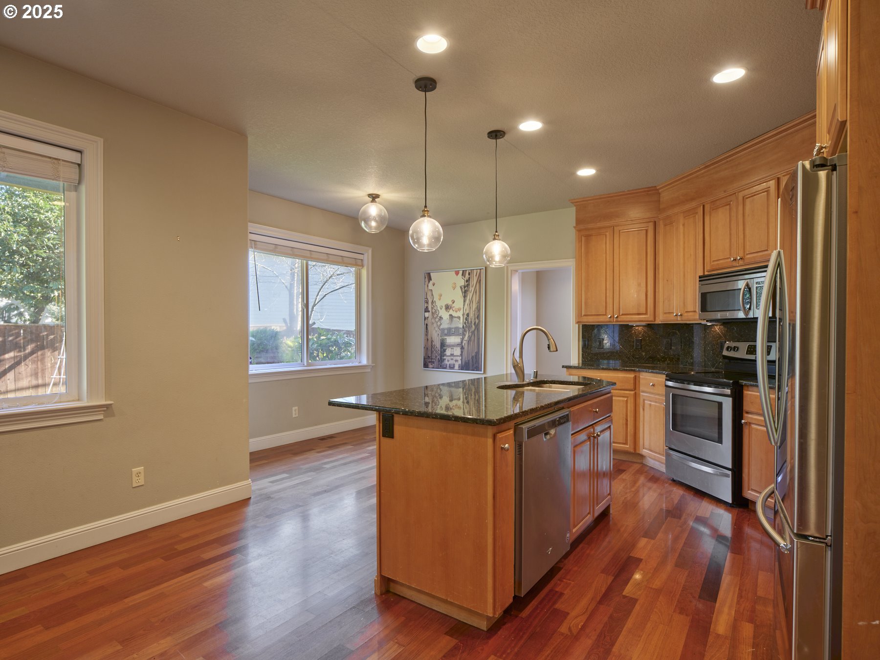 10410 Southeast French Road Vancouver, WA 98664 - Photo 15 of 43 a kitchen with stainless steel appliances granite countertop wooden floors and sink