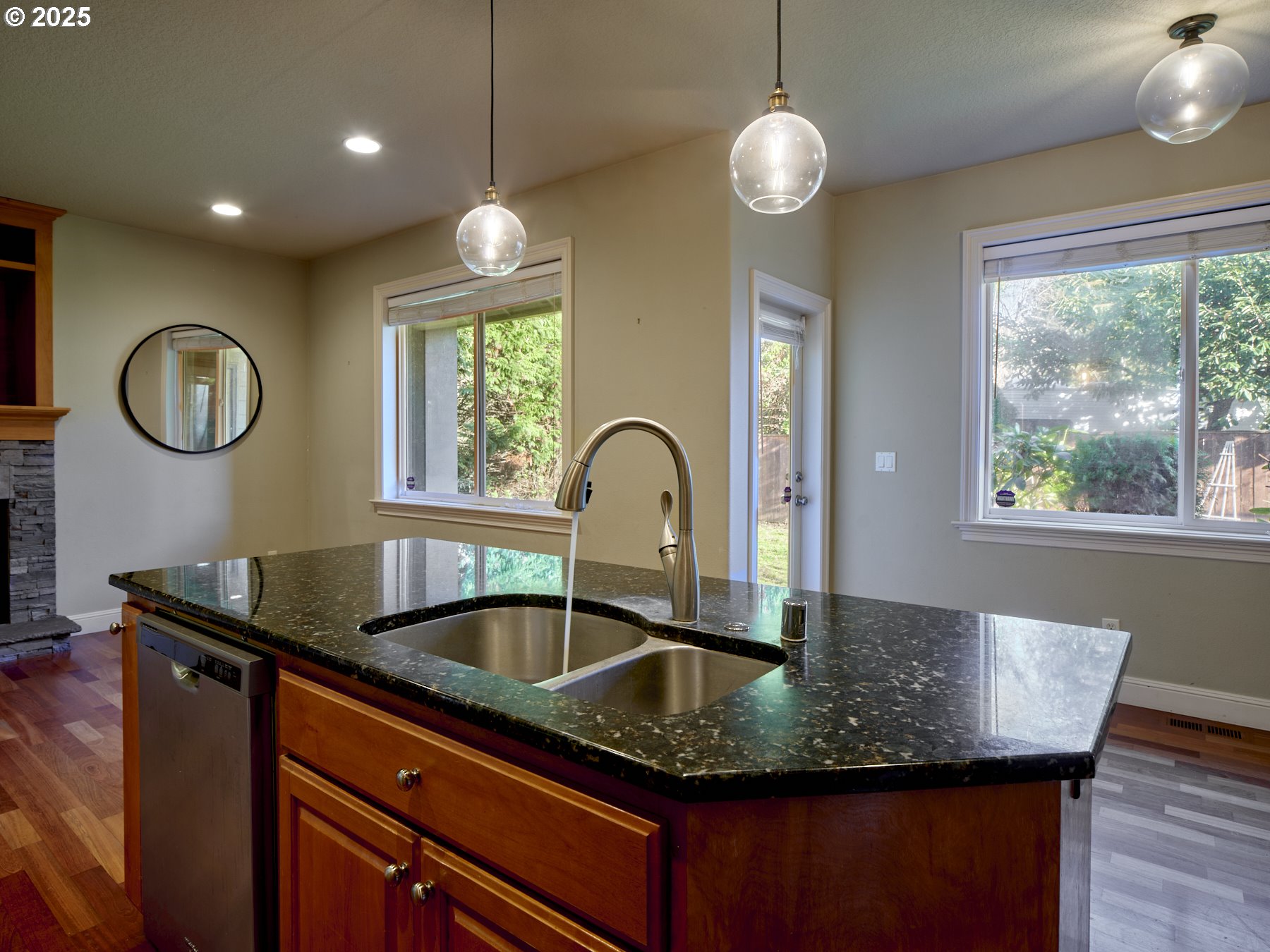 10410 Southeast French Road Vancouver, WA 98664 - Photo 16 of 43 a kitchen with granite countertop a sink a window and wooden floor