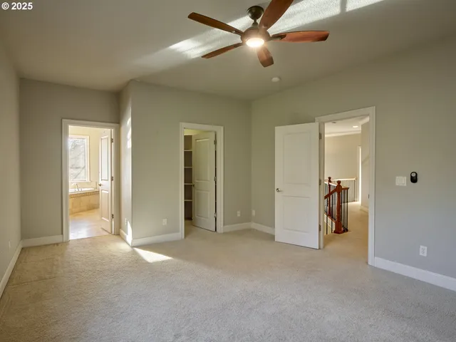 a view of empty room with ceiling fan