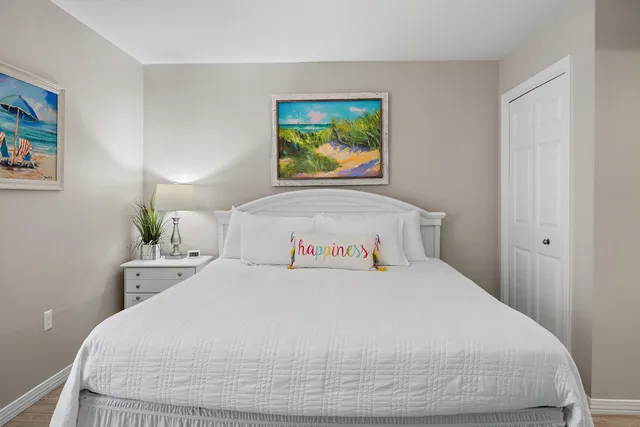 a bedroom with a bed and painting on the wall