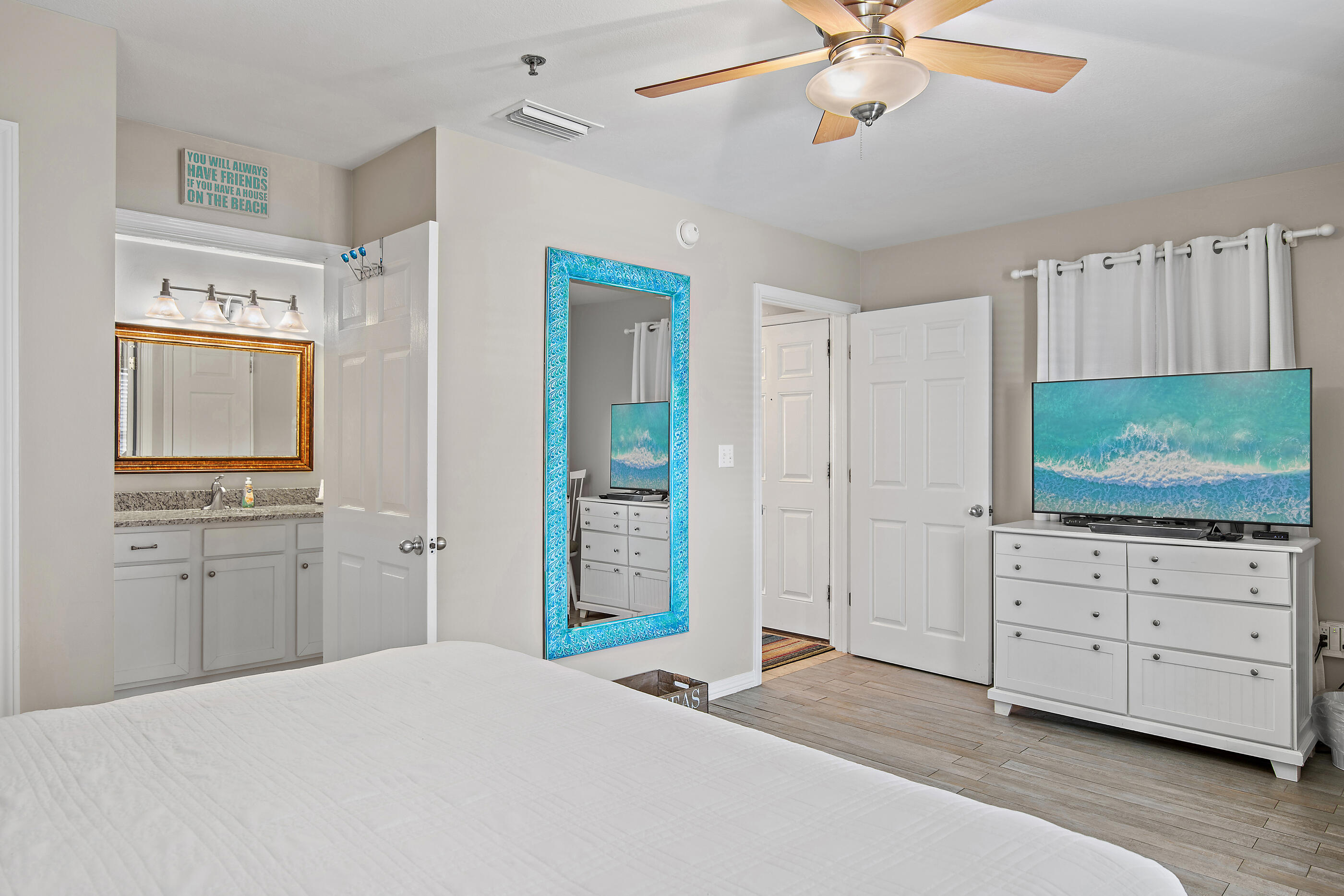 144 Spires Lane, Unit 107 Santa Rosa Beach, FL 32459 - Photo 12 of 34 a bedroom with a bed and a flat screen tv in it