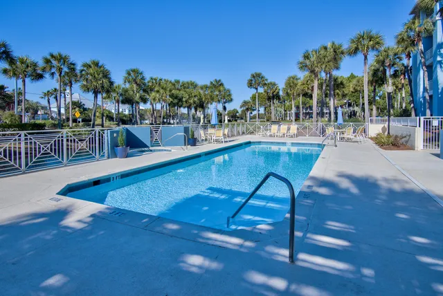 a view of swimming pool with outdoor seating and plants