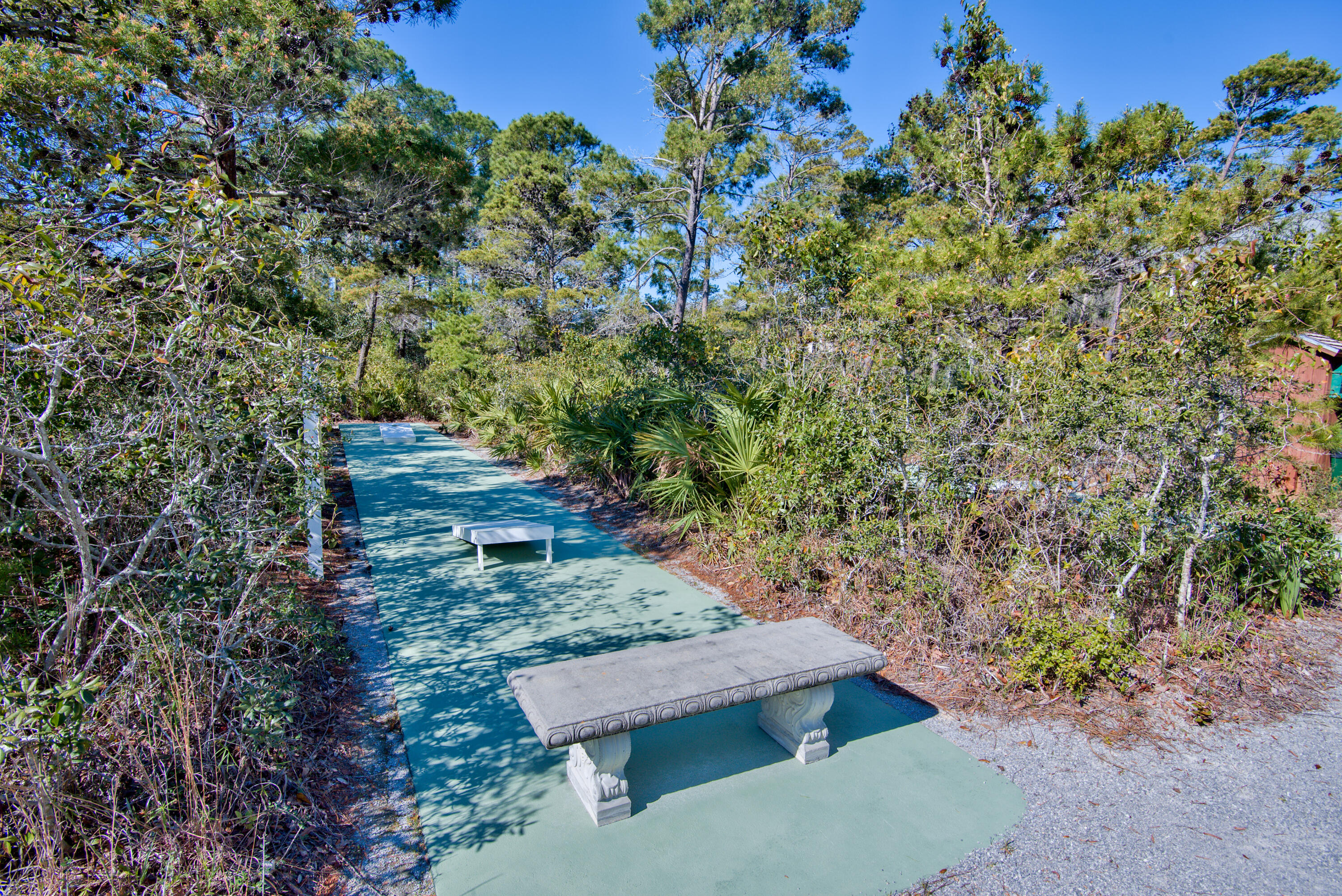 144 Spires Lane, Unit 107 Santa Rosa Beach, FL 32459 - Photo 30 of 34 a wooden bench sitting in the middle of a forest