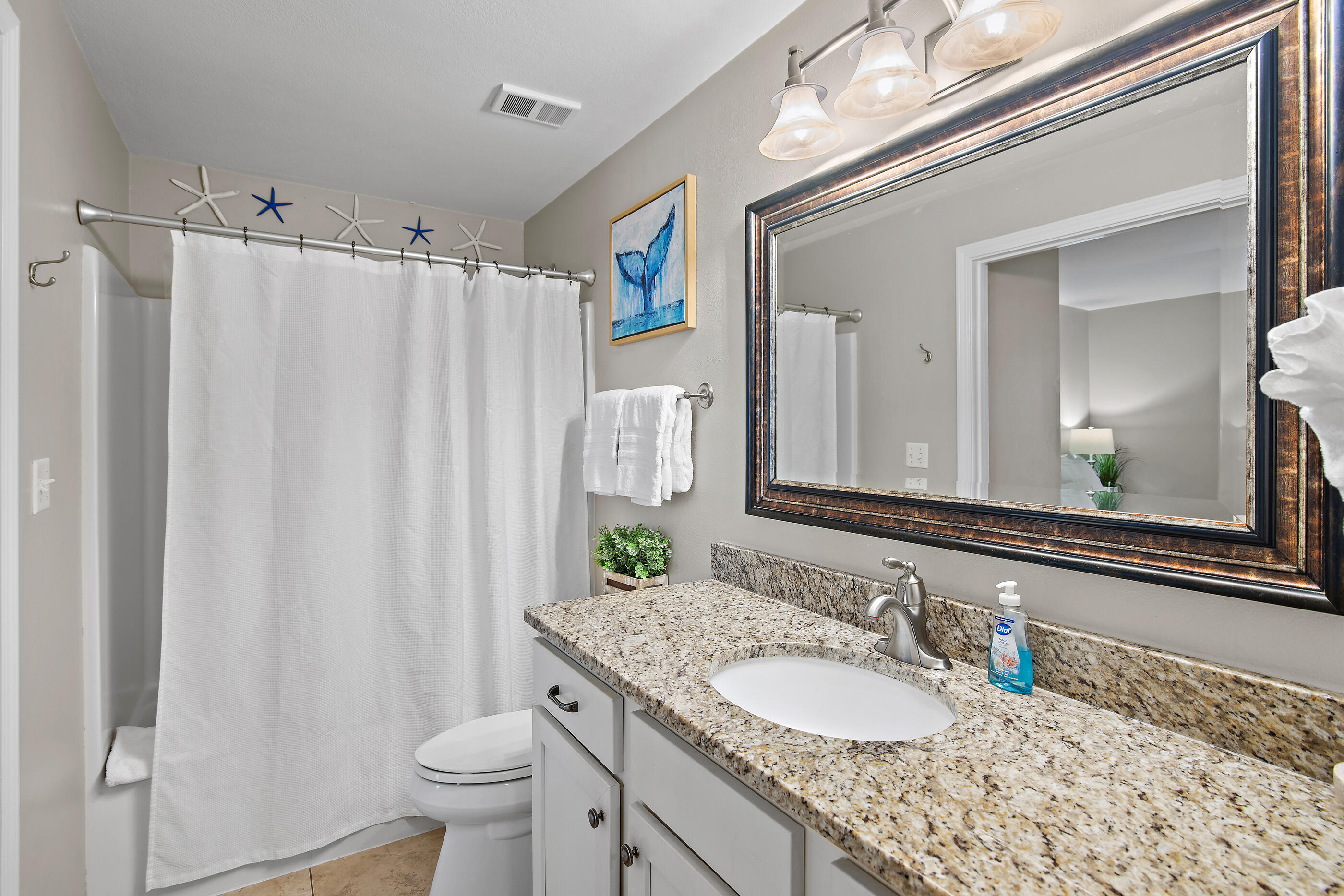 144 Spires Lane, Unit 107 Santa Rosa Beach, FL 32459 - Photo 10 of 34 a bathroom with a granite countertop sink toilet and a mirror