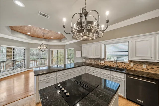 a kitchen with a stove a sink and cabinets