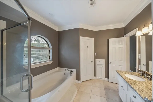 a spacious bathroom with a tub sink and mirror