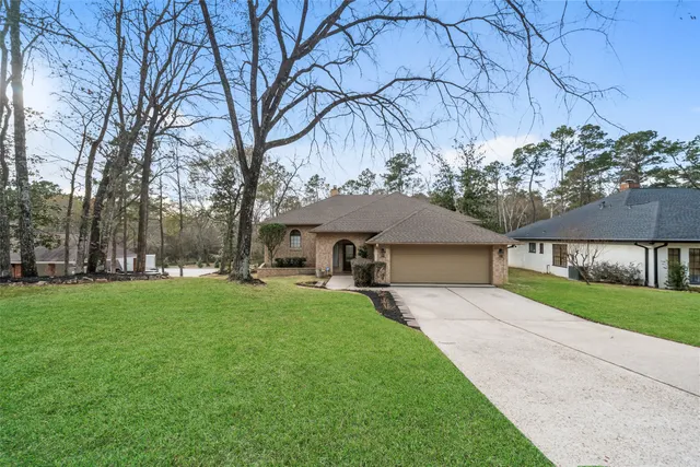 a front view of house with yard and trees