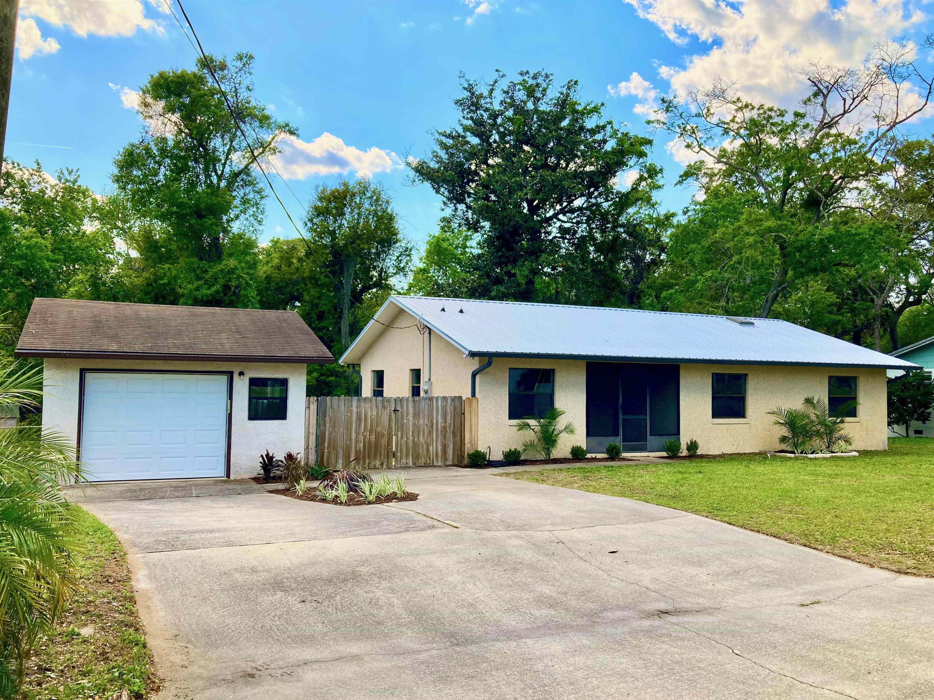 356 Cypress Road St. Augustine, FL 32086 - Photo 1 of 40 a front view of a house with a garden