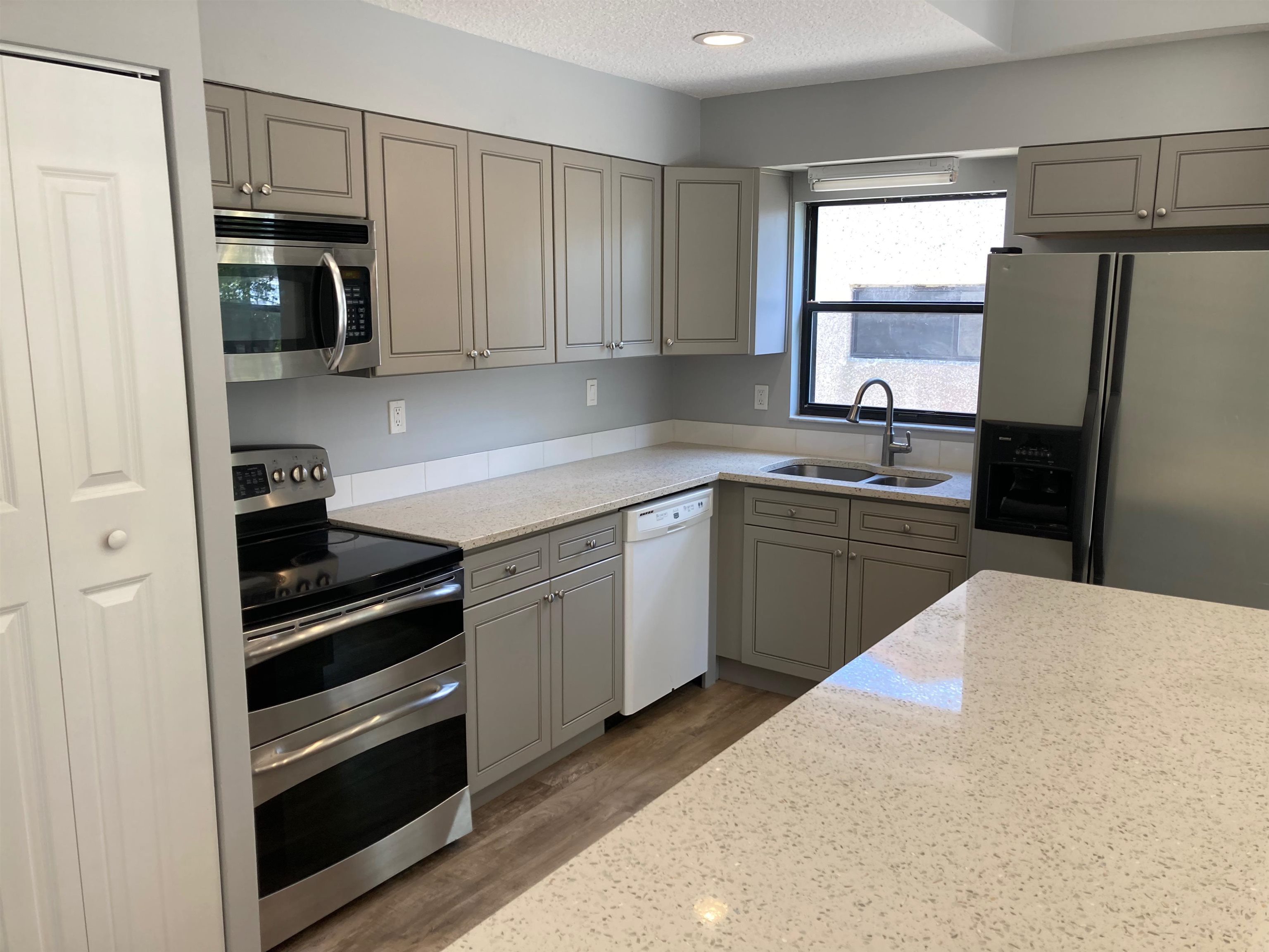 356 Cypress Road St. Augustine, FL 32086 - Photo 12 of 40 a kitchen with a sink stove and refrigerator