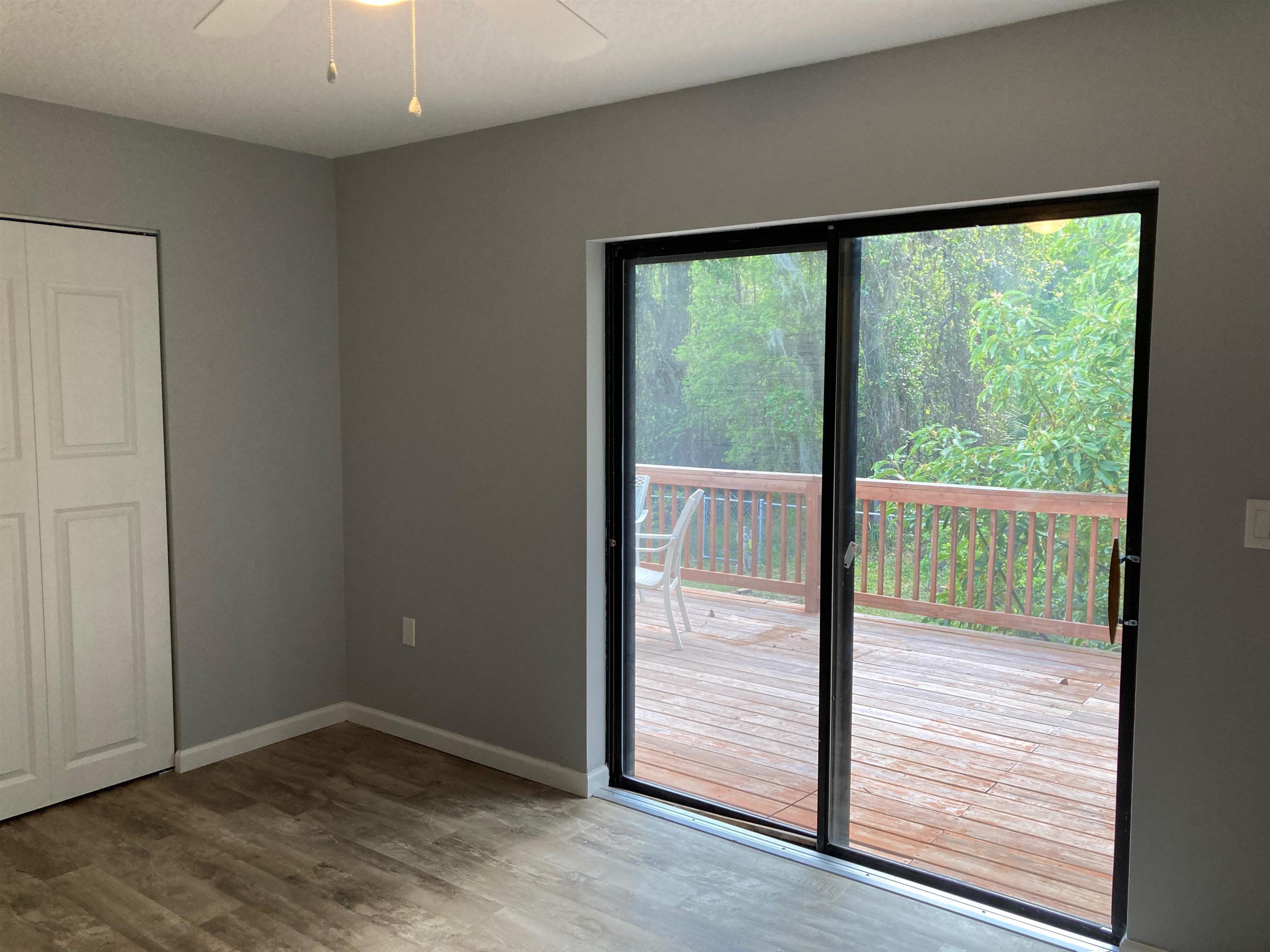 356 Cypress Road St. Augustine, FL 32086 - Photo 14 of 40 an empty room with wooden floor and windows