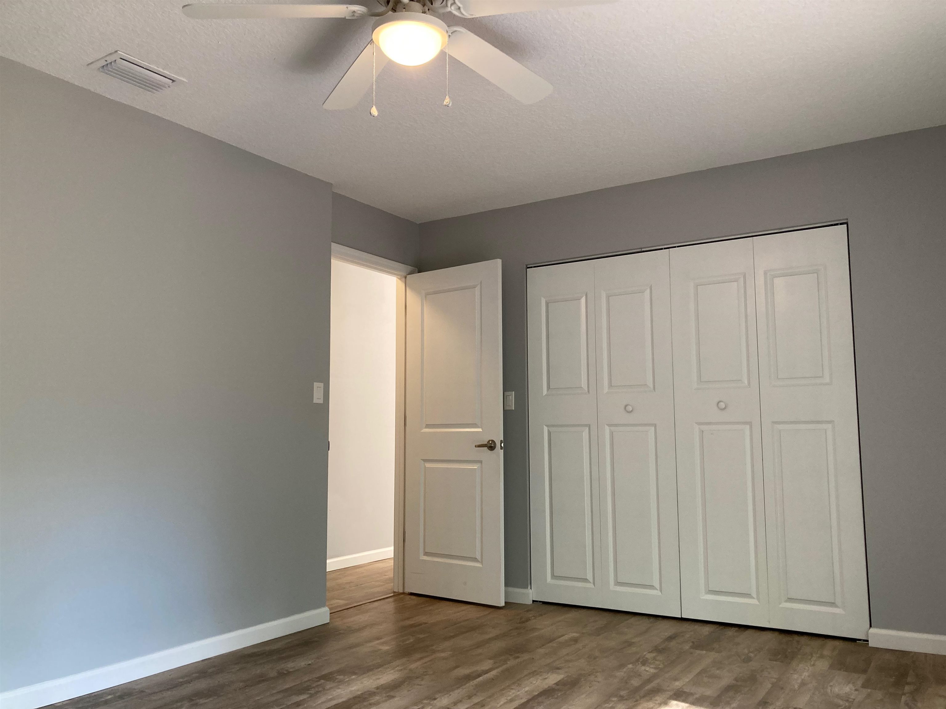 356 Cypress Road St. Augustine, FL 32086 - Photo 15 of 40 an empty room with wooden floor and closet area