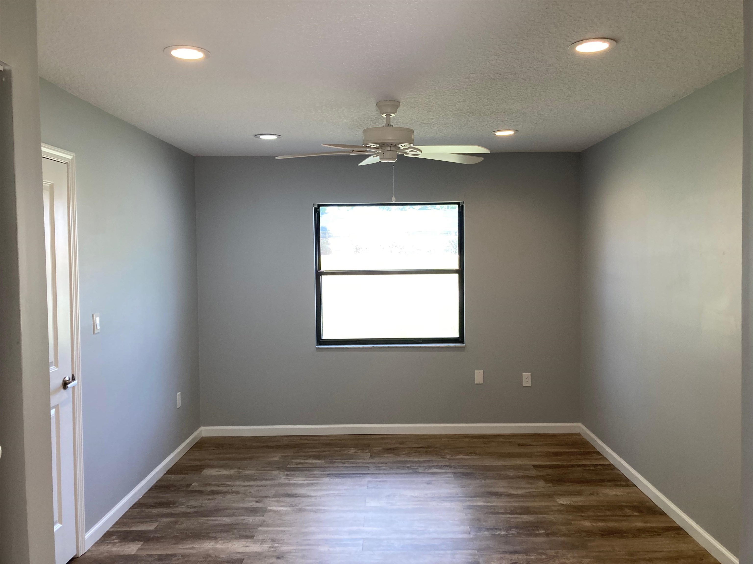 356 Cypress Road St. Augustine, FL 32086 - Photo 18 of 40 an empty room with wooden floor and windows