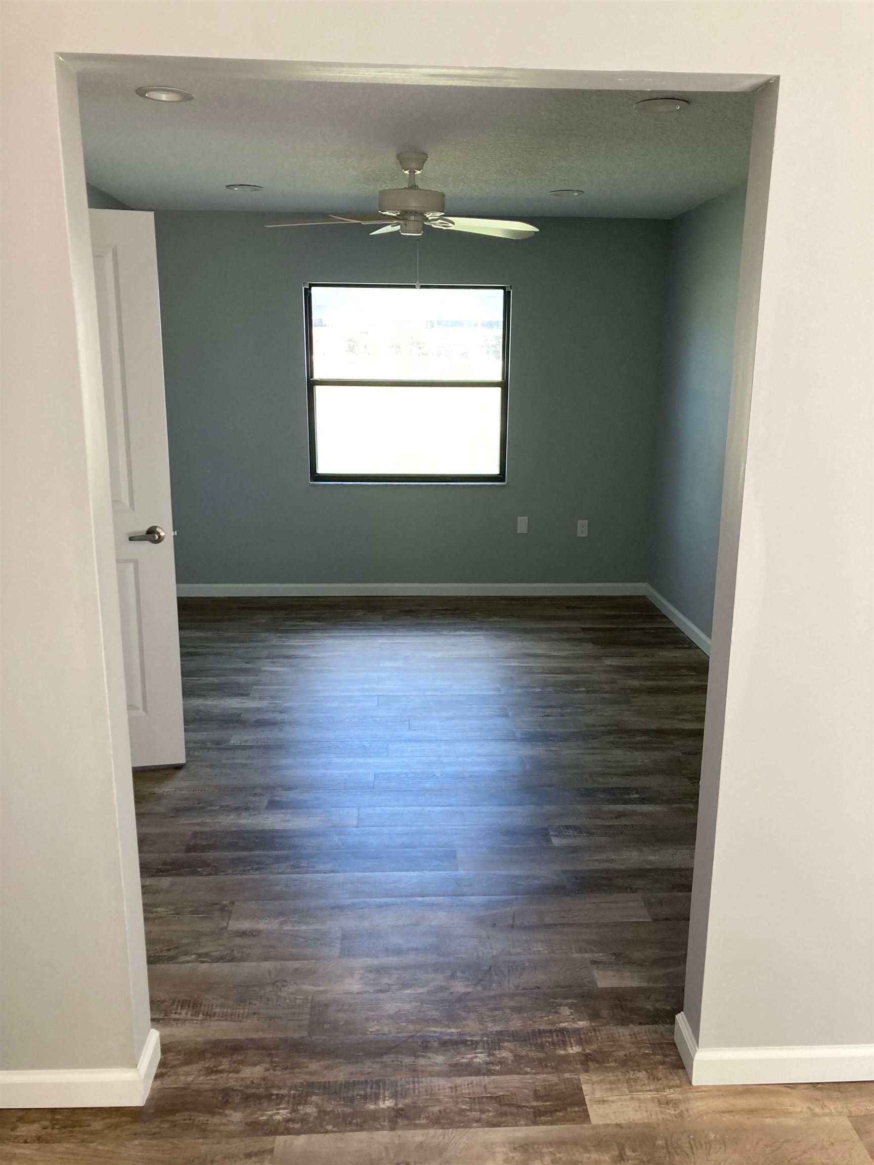 356 Cypress Road St. Augustine, FL 32086 - Photo 20 of 40 an empty room with wooden floor cabinet and windows
