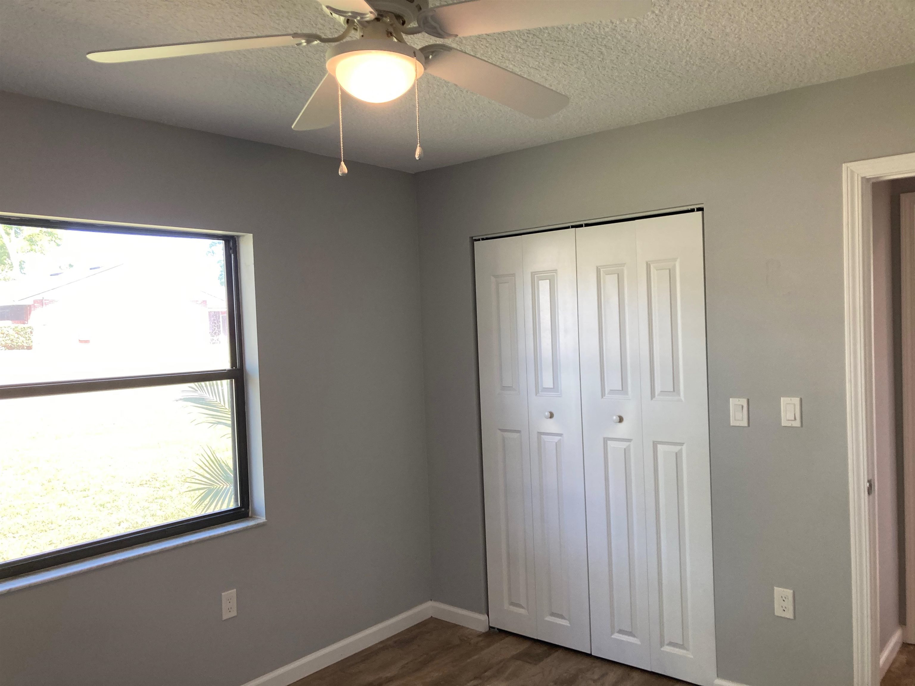 356 Cypress Road St. Augustine, FL 32086 - Photo 23 of 40 a view of an empty room with a window and wooden floor