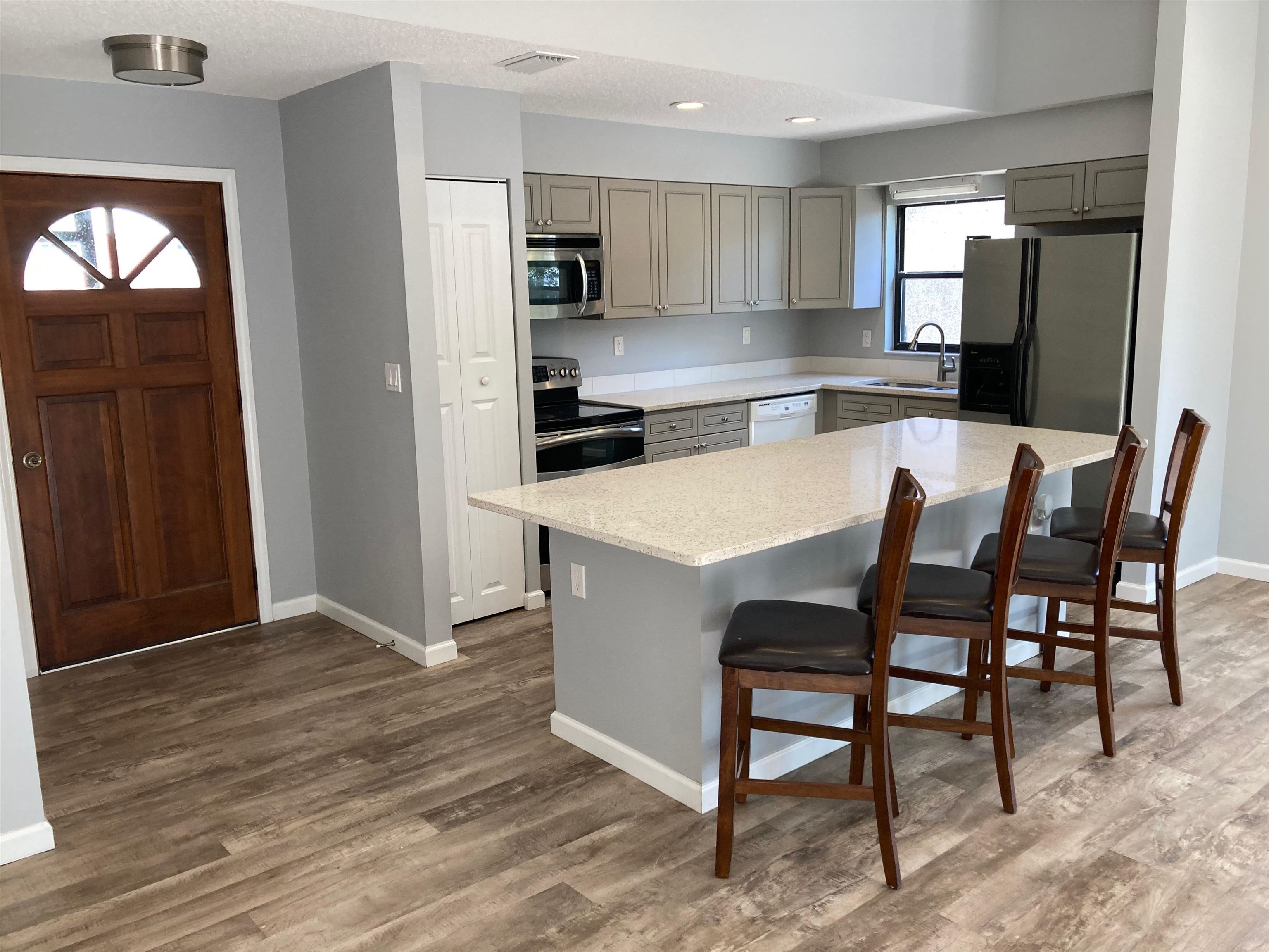 356 Cypress Road St. Augustine, FL 32086 - Photo 9 of 40 a kitchen with a table chairs refrigerator and cabinets